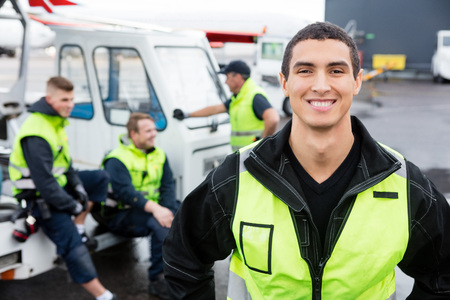 Confident Worker Smiling While Colleagues Communicating At Gangwの写真素材