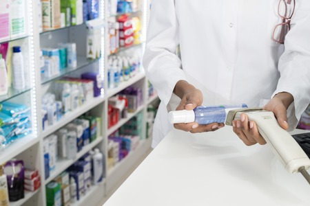 Midsection Of Chemist Scanning Barcode Of Productの写真素材