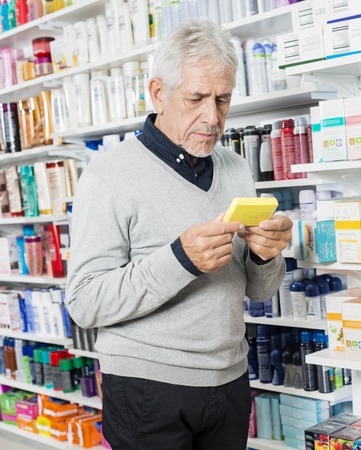 Senior Customer Holding Box In Pharmacyの写真素材