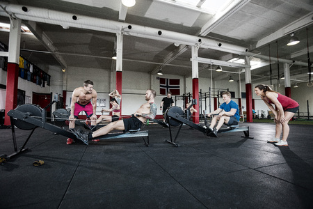 Instructors Motivating Clients Exercising In Gymの写真素材