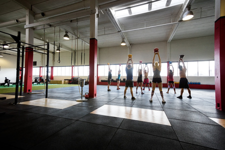 Males And Females Lifting Kettlebellsの写真素材