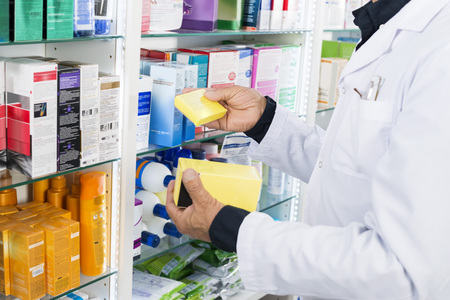 Midsection Of Chemist Holding Medicine Boxesの写真素材