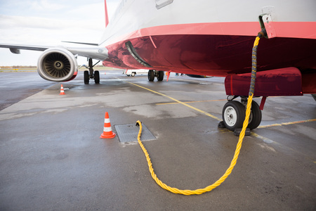 Airplane Being Charged On Runwayの写真素材