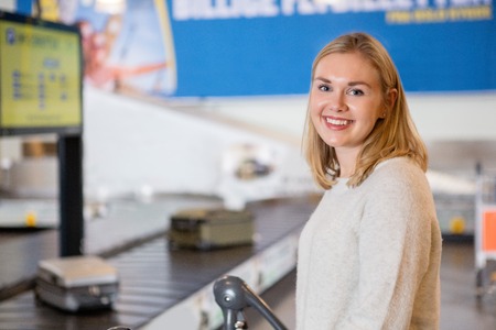 Beautiful Young Woman Smiling At Airportの写真素材