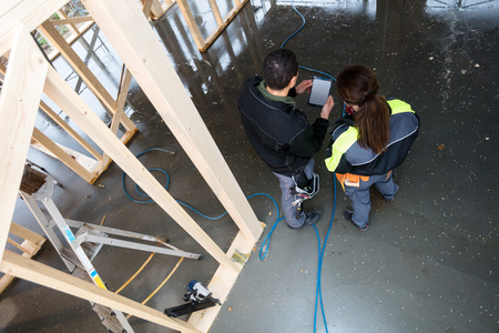 Rear View Of Workers With Digital Tablet At Siteの写真素材