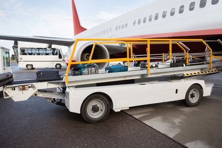Luggage On Conveyor Belt Being Unloadedの写真素材