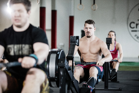 Muscular Man Exercising On Rowing Machine In Gymの写真素材