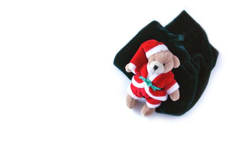santa teddy with his sack over a white backgroundの写真素材