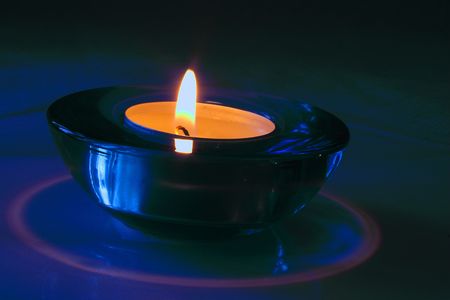 candle in a blue glass holderの写真素材