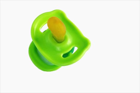 babies green dummy over a white backgroundの写真素材