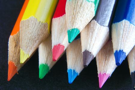 points of crayons isolated over blackの写真素材