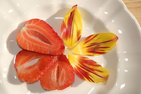 sliced strawberry with petal decorationの写真素材