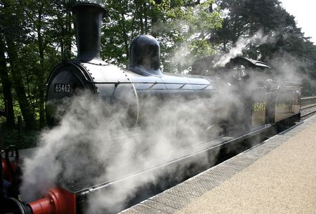 steam engine creating alot of steam around its base