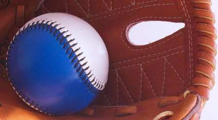 macro shot of a baseball inside a baseball gloveの写真素材
