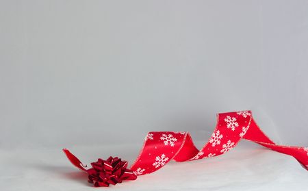 red christmas ribbon with a bowの写真素材