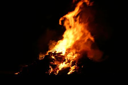 flames rising hight into the night sky from  a large bonfireの写真素材