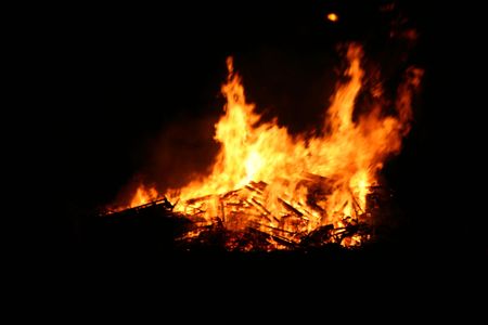 flames rising hight into the night sky from  a large bonfireの写真素材
