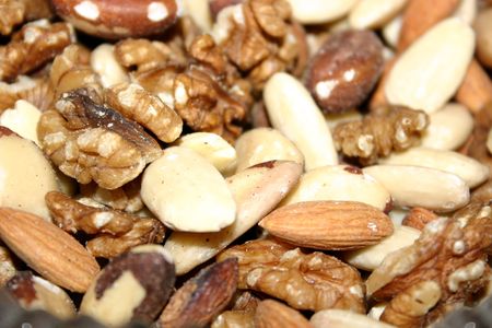 assorted fresh nuts ready shelled and in the dishの写真素材
