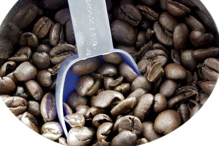 coffee beans and blue plastic scoop in a canの写真素材