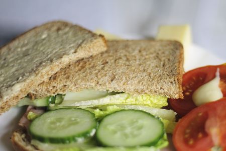 wholemeal salad sandwich with cucumber lettuce and tomatoesの写真素材