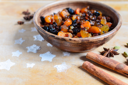 Dried fruits and spices on the wooden board. Christmas baking.の写真素材