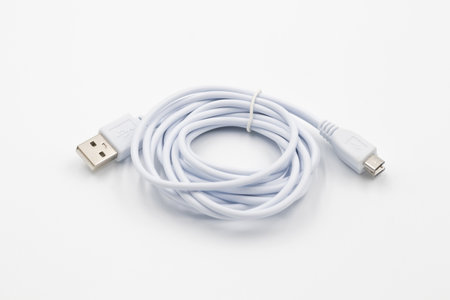USB cable for smartphone on white background, White usb cable on white background, computer peripherals connector or smartphone recharge supplyの写真素材