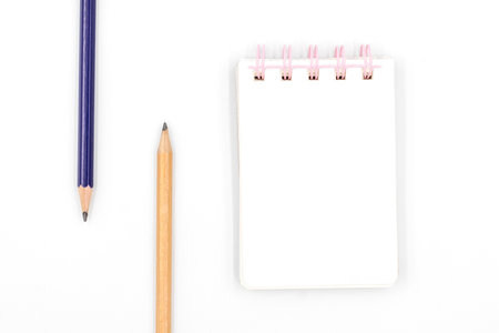 School notebook with pencil on white backgroundの写真素材