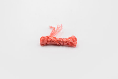 tying straw rope on white backgroundの写真素材