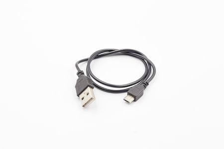 USB cable for smartphone on white background, Black usb cable on white background, computer peripherals connector or smartphone recharge supplyの写真素材