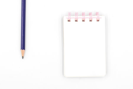School notebook with pencil on white backgroundの写真素材