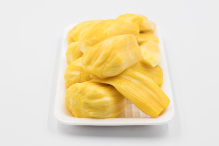 Ripe jackfruit flesh in a white plate, Close-up of jackfruit on white background, Ripe Jackfruit on white background.の写真素材