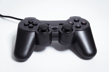 Black controller on white background, Video game device, Joystick on a white background.