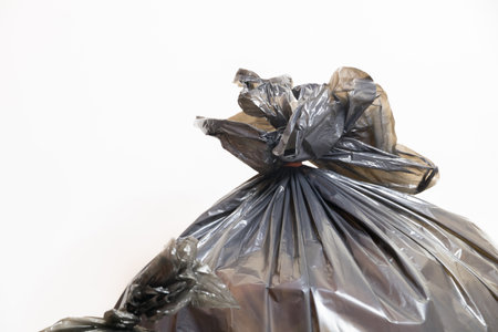 plastic trash bags on white background, black plastic garbage bags on white backgroundの写真素材
