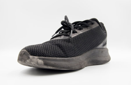 shoe sneaker on white background, close up of sneaker on white background, old black generic sneakers on white background.の写真素材