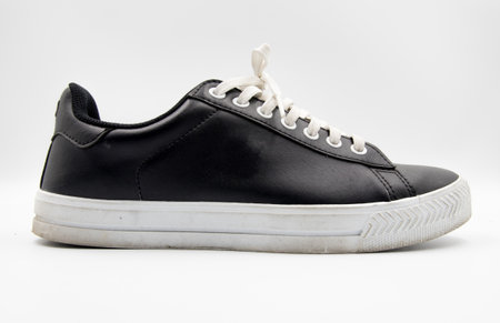 shoe sneaker on white background, close up of sneaker on white background, old black generic sneakers on white background.の写真素材