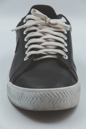 shoe sneaker on white background, close up of sneaker on white background, old black generic sneakers on white background.の写真素材