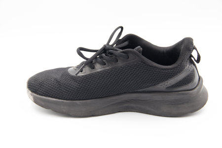 shoe sneaker on white background, close up of sneaker on white background, old black generic sneakers on white background.の写真素材