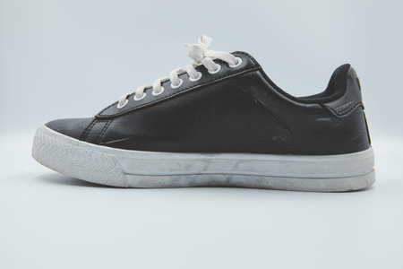 shoe sneaker on white background, close up of sneaker on white background, old black generic sneakers on white background.の写真素材