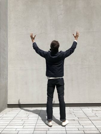 Excited man back arm raised full lengthの写真素材