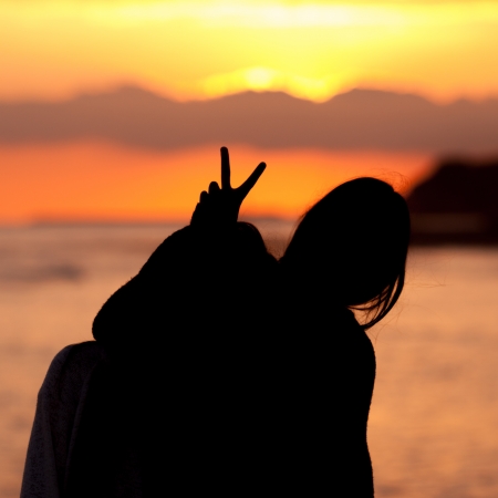 Young woman couple  silhouette bunny on sunsetの写真素材