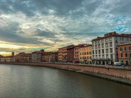 View of old buildings near the river Arno in Pisa, Italyの写真素材