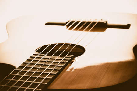 For music lovers. A close-up of the different parts of a wooden acoustic guitar such as the bridge, the body, the strings.の写真素材