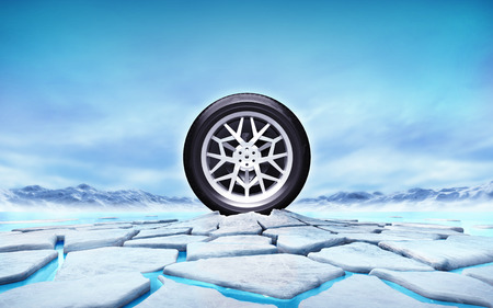 winter tire in the middle of ice floe cracked holeの写真素材