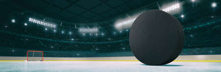 Sport indoor ice hockey arena with black puck on the ice rink as widescreen background. Digital 3D illustration of sport building interior.の写真素材