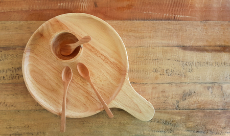 plate cup and spoon empty make with wooden top view on wooden backgroundの写真素材