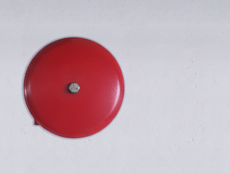 Fire alarm bell on white wall background.の写真素材
