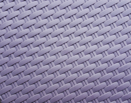 Synthetic rattan texture weaving background as used on outdoor garden furniture.の写真素材