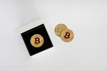 Gold Bitcoin coins in leather box on a grey background. with clipping pathの写真素材