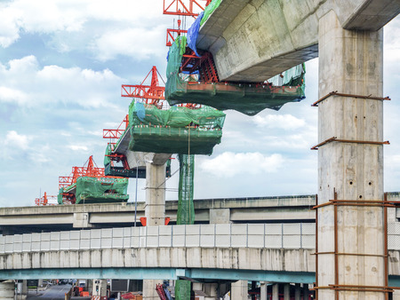 Construction site linking a single track railway track with a crane in between. Urban development.