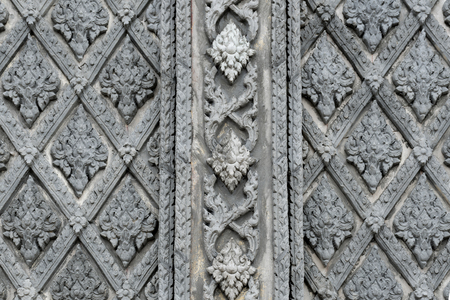 Thai style stucco on the wall and temple wallの写真素材